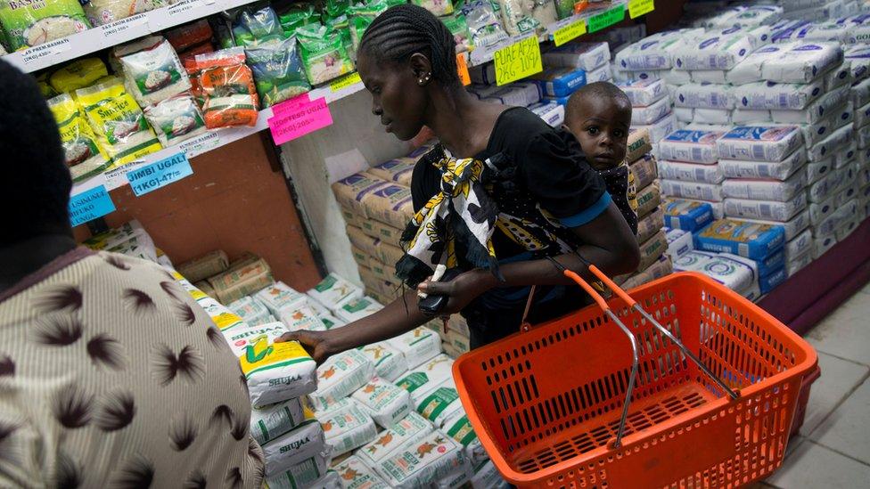 A woman buys a packet of maize flour subsidised by the government at a supermarket in Kenya's capital, Nairobi, on Wednesday.