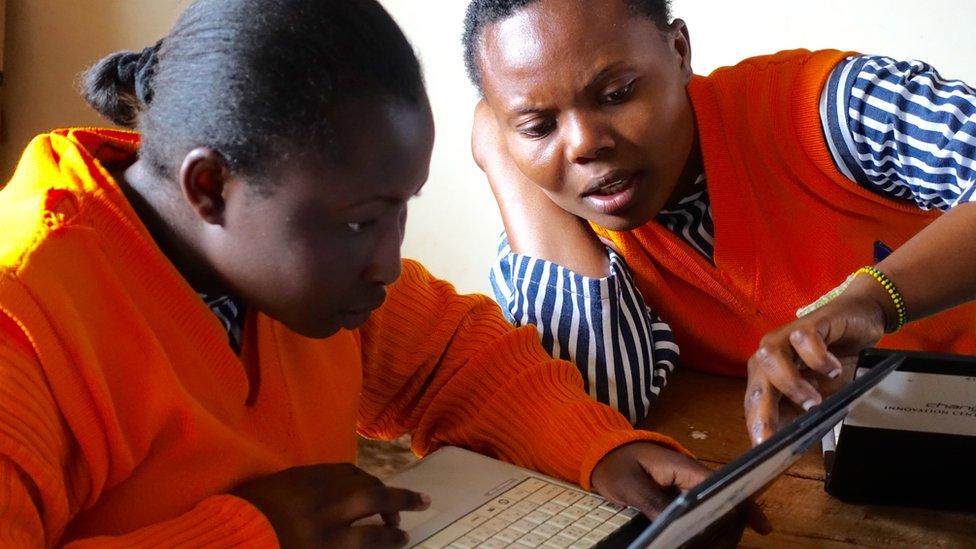 Two women looking at a laptop