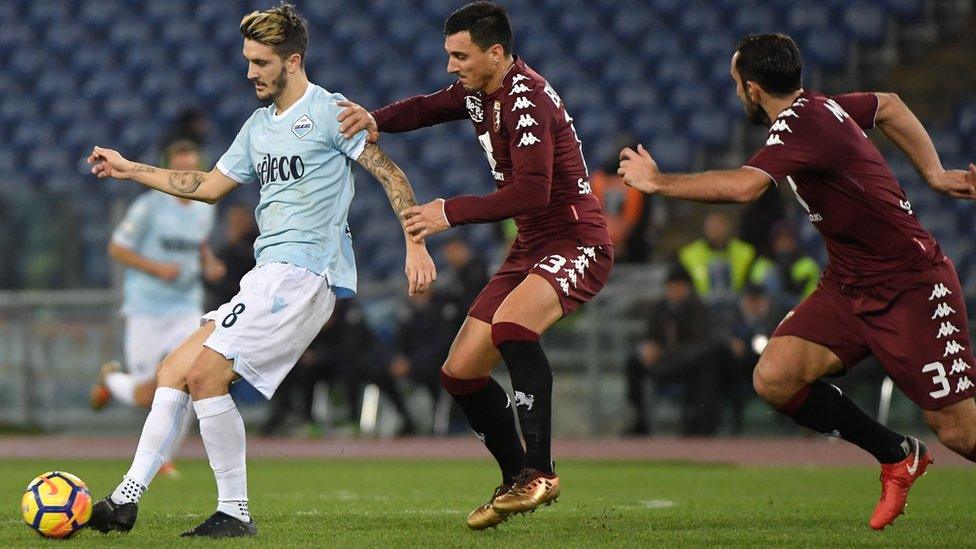 Lazio"s Spanish midfielder Luis Alberto vies for the ball with Torino"s Argentinian defender Nicolas Burdisso during match