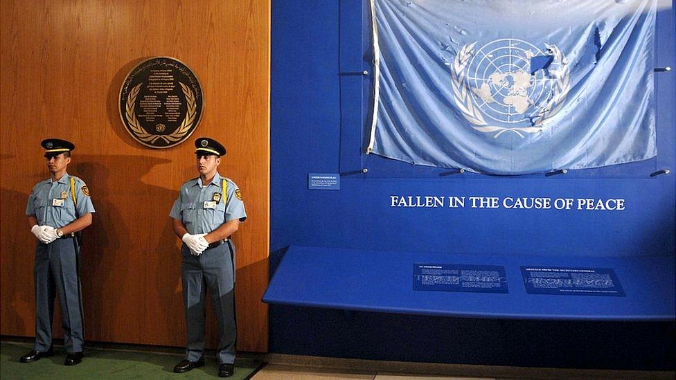 The flag that flew at the United Nations compound in Baghdad is now displayed next to a plaque honouring the UN Staff members killed in a suicide attack on 19 August 2003