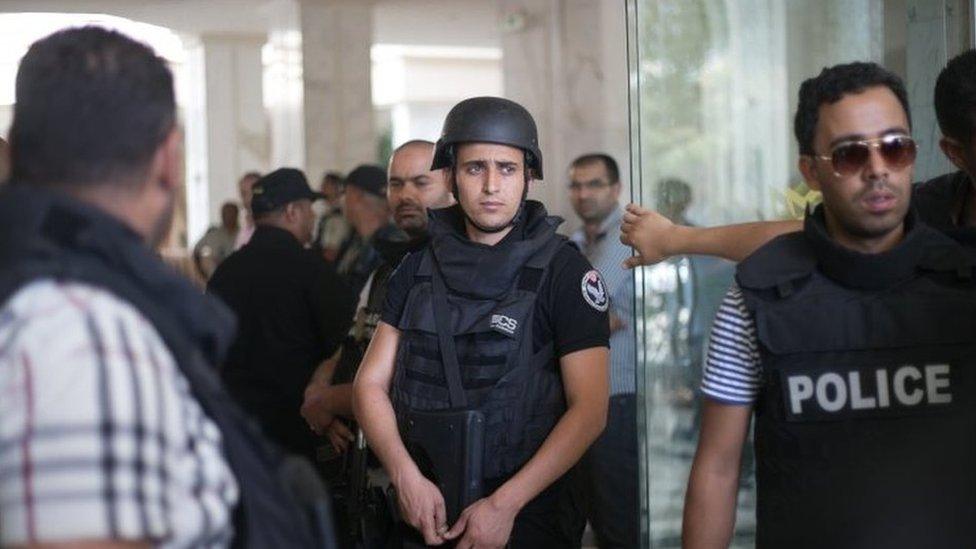 Tunisian police officers stay in the lobby of an hotel where a terrorist attack took place in the coastal town of Sousse, Tunisia, Friday June 26, 2015.