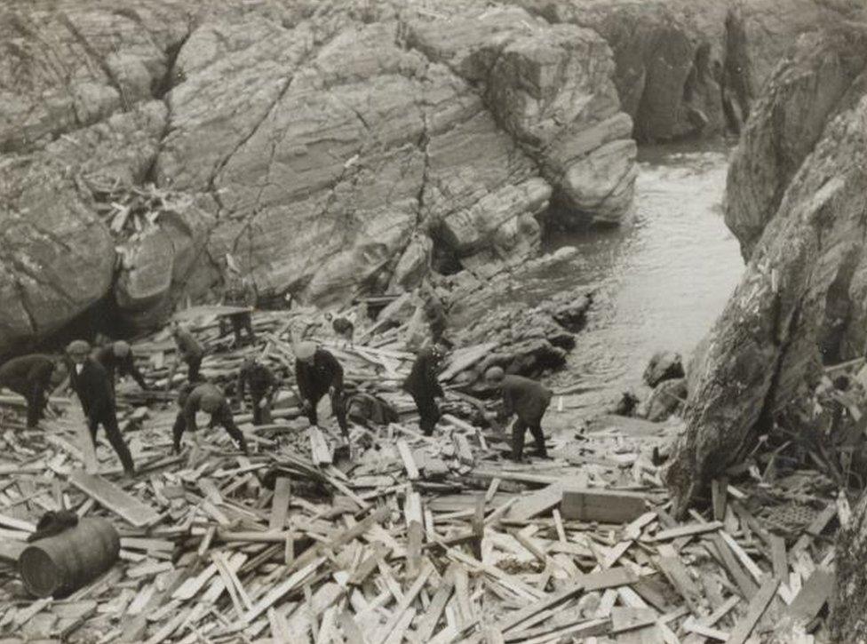 Searching in the wreckage for bodies of victims of the U.S. troopship Otranto which was wrecked off the coast of Islay, Scotland. Nearly 450 lives were lost