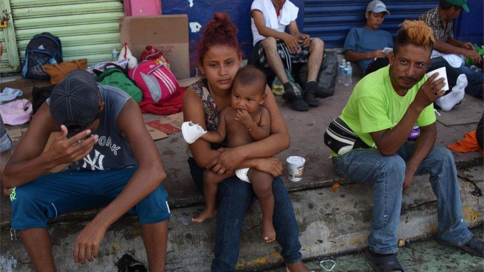 Honduran migrants taking part in a caravan heading to the US, rest during a stop in their journey, in Huixtla, Chiapas state, Mexico