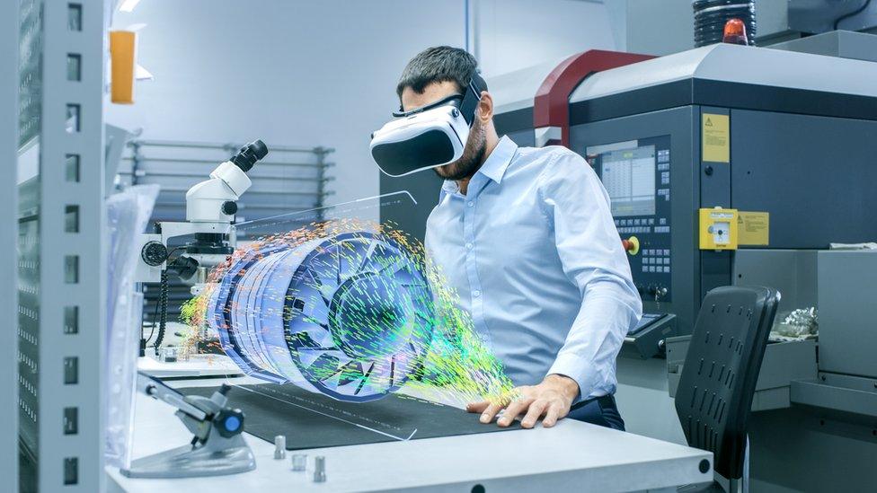 Man wearing VR headset looking at virtual turbine