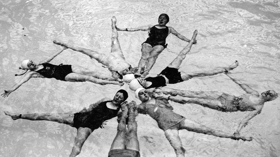 Synchronised swimmer in the star formation at Wembley pool.