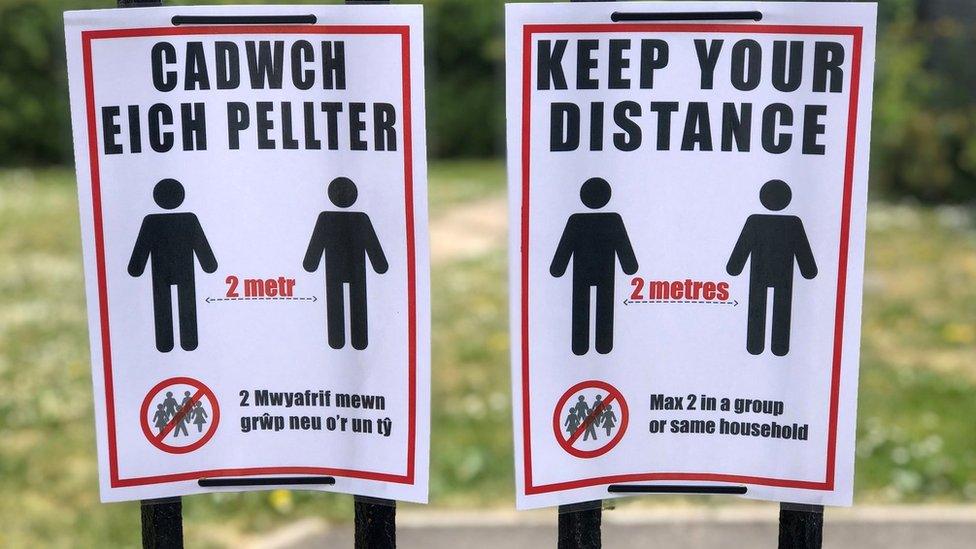 Social distancing guidance pinned to a park gate in Penarth