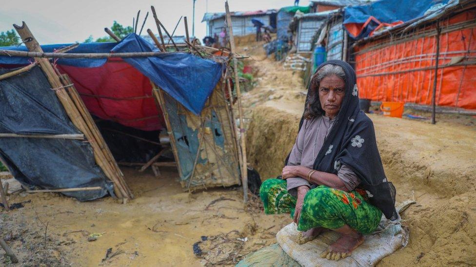 Woman next to flooded shelter