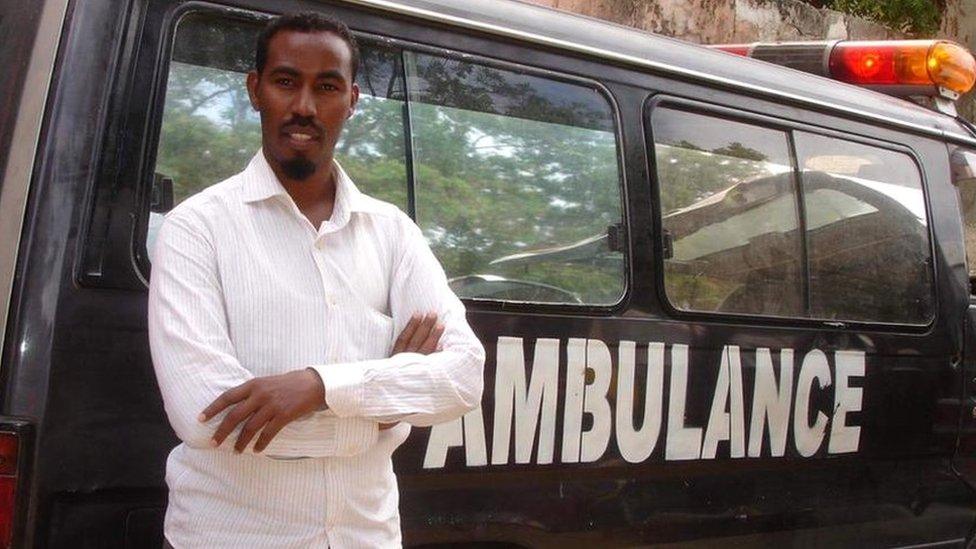 Abdulkadir Abdirahman Adan standing against an ambulance