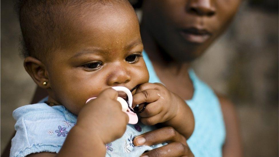 Stock image of woman holding a baby