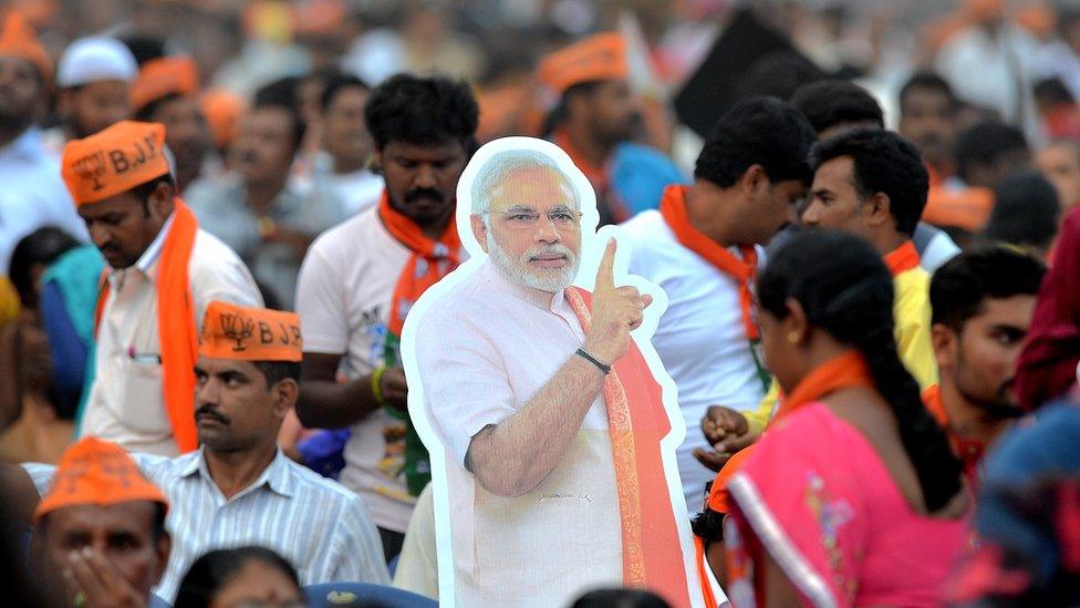 BJP supporters take part in an election campaign rally held in Bangalore on May 3, 2018.