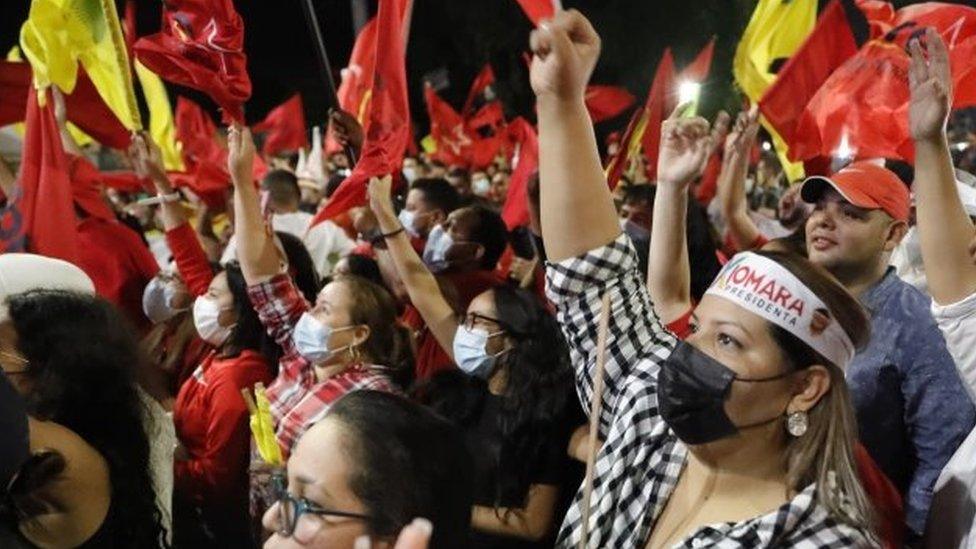 Supporters of the presidential candidate Xiomara Castro await outside her campaign headquarters after hearing the partial results of the elections, in Tegucigaloa, Honduras, 28 November 2021.