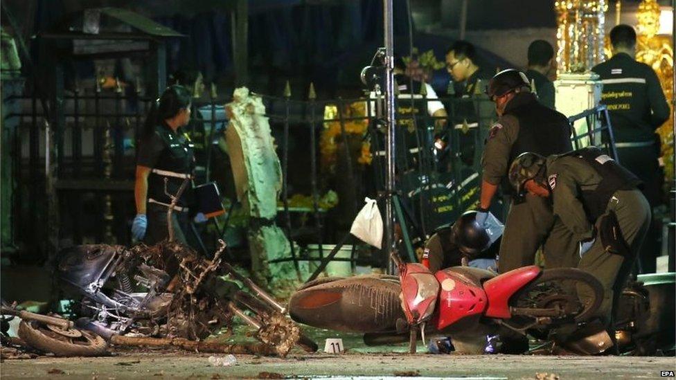 Police inspect motorbike at scene of blast in Bangkok