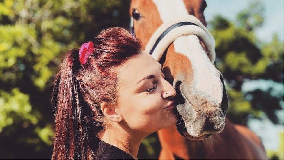 Jade Randall kissing a horse