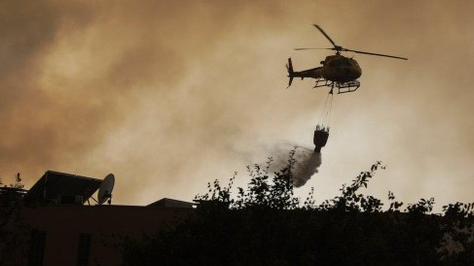 A helicopter fights a forest fire in Vila Cha, Lousa, Portugal, 15/10/2017