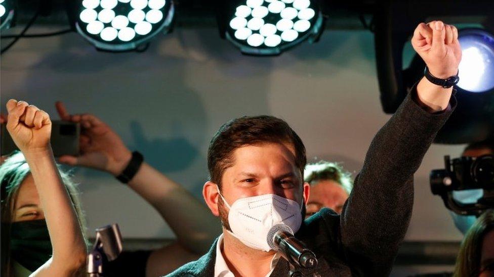 Presidential candidate Gabriel Boric raises his fist after the partial results of the first round vote during the presidential elections, in Santiago, Chile, November 21, 2021.