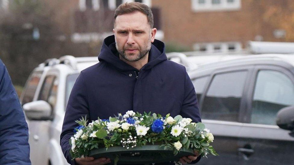 Birmingham City Football Club head coach John Eustace laying flowers near to the scene in Babbs Mill Park in Kingshurst, Solihull