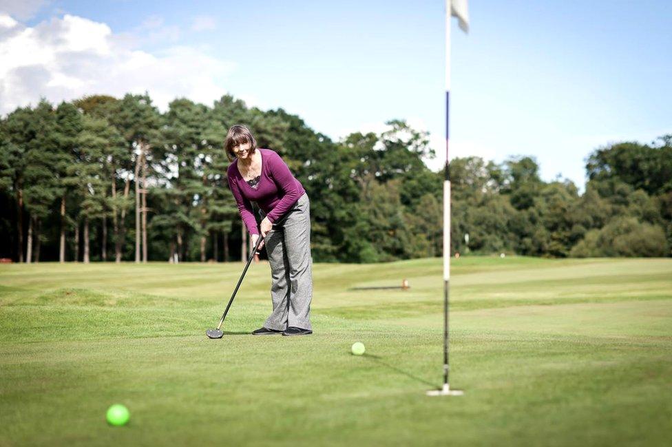 Woman lines up her shot