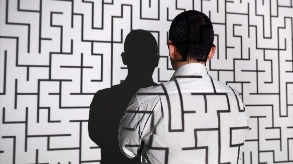 Man standing in front of labyrinth