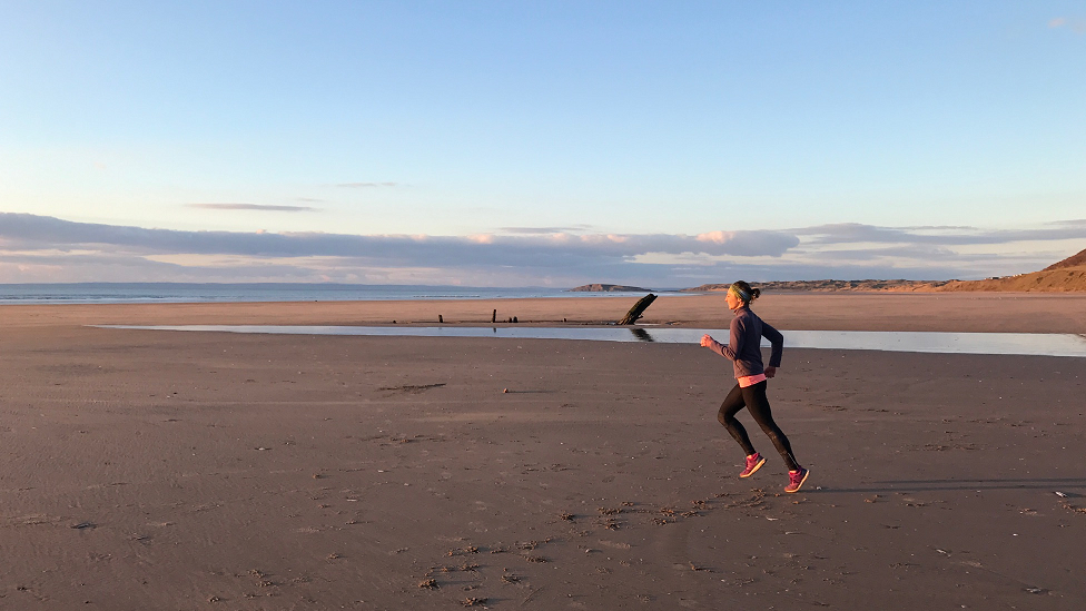 Ellie Lacey running on the beach