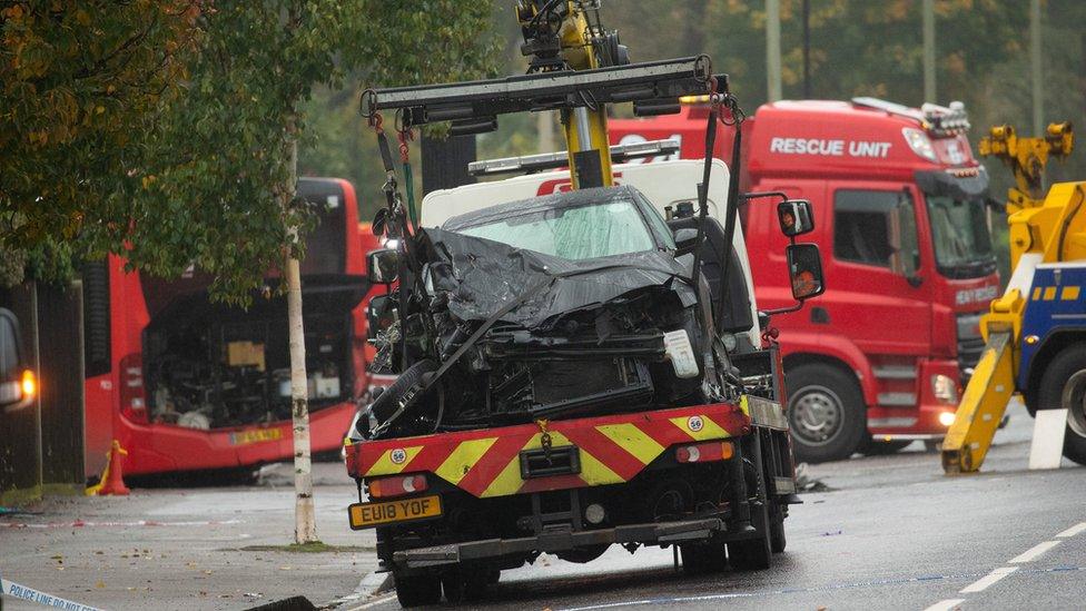 Crushed car being taken away