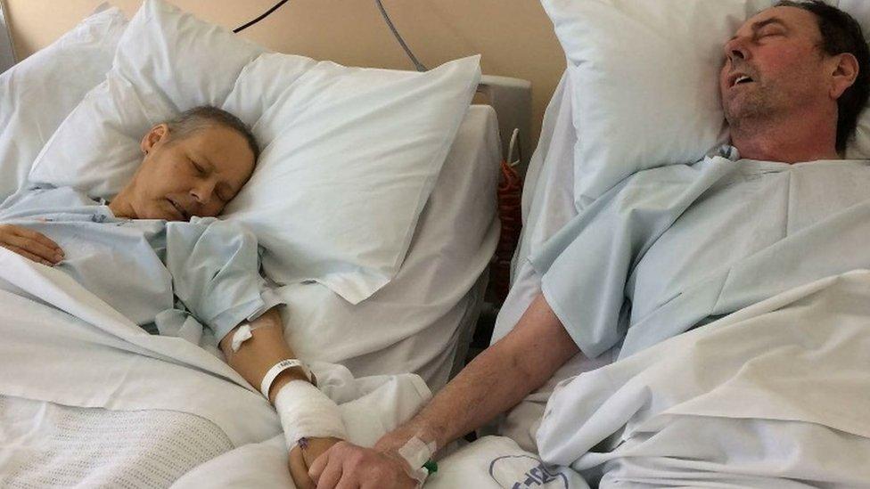 Julie and Mike Bennet in hospital holding hands