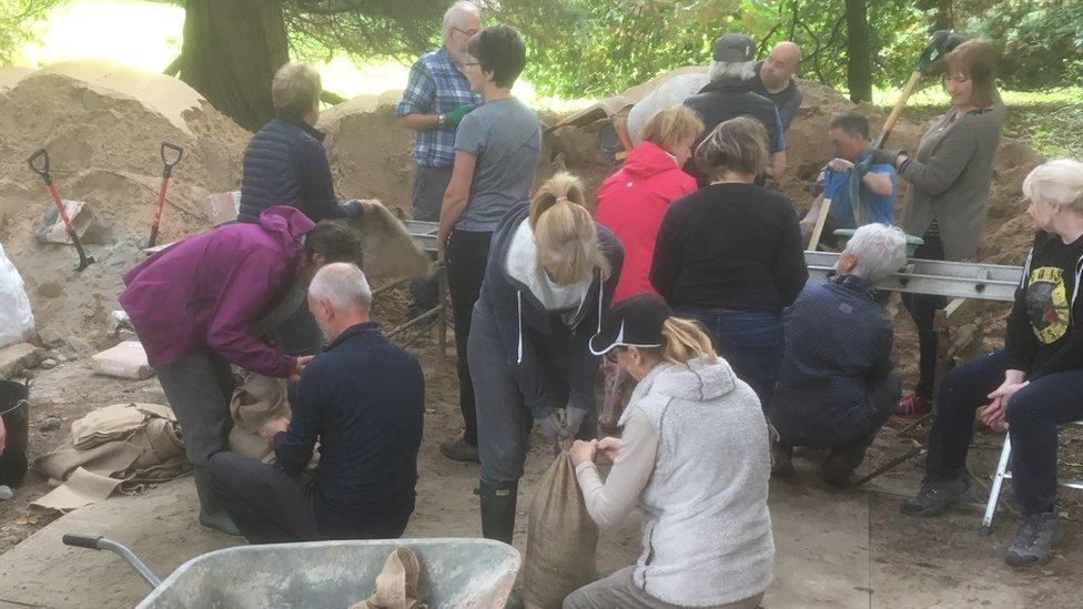 Volunteers fill sandbags