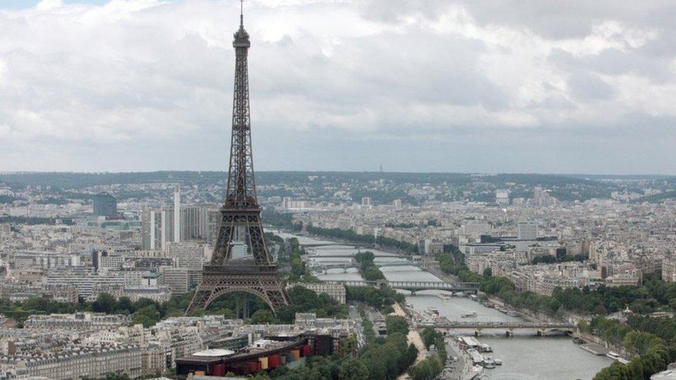 This aerial picture taken on July 14, 2012 shows a general view of Paris with the Eiffel Tower (L) and the Seine River.