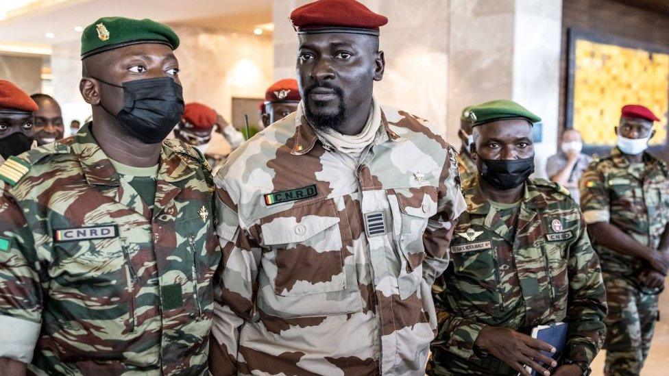 President of the National Committee for Rally and Development (CNRD) Colonel Mamady Doumbouya (C) leaves a meeting with high level representatives of the Economic Community of West African States (ECOWAS) in Conakry on September 17, 2021