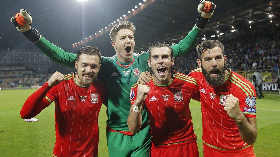 Jubilant players (l-r) Aaron Ramsey, goalkeeper Wayne Hennesey, Gareth Bale and Joe Ledley celebrate on the pitch.