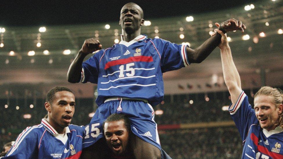 Former French striker Lilian Thuram (top) celebrates with (L-R) Thierry Henry, Bernard Lama and Emmanuel Petit