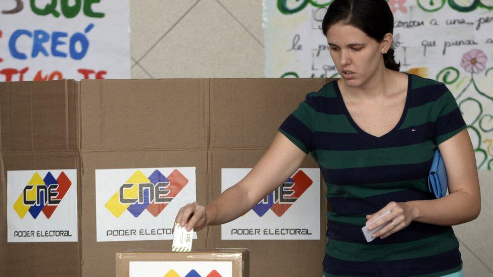 A woman votes in Caracas