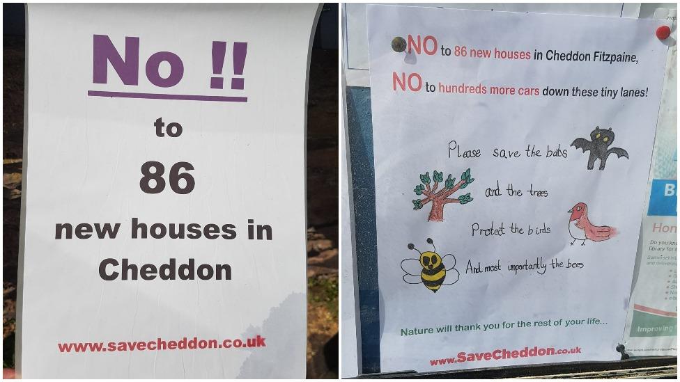 Signs protesting the new homes