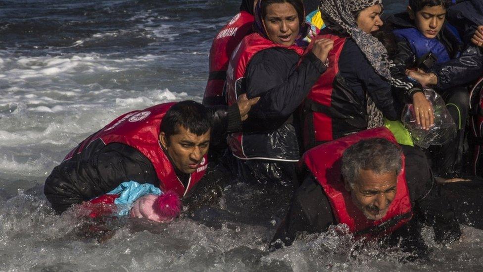 Migrants disembark from their boat on the Greek island of Lesbos after crossing the Aegean Sea from Turkey. File photo