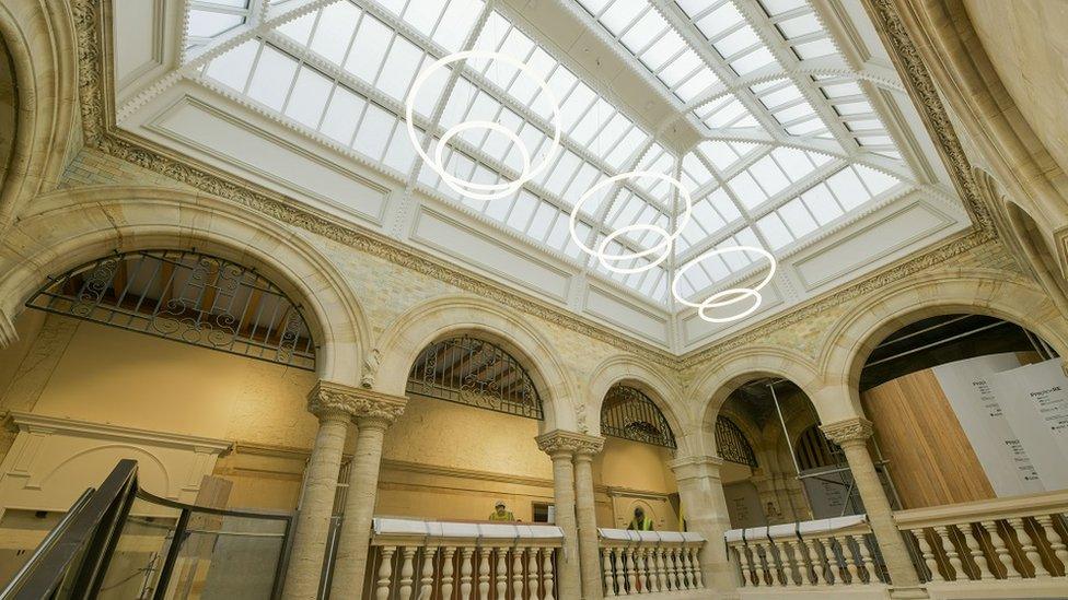 A room with archways and a glass vaulted ceiling.