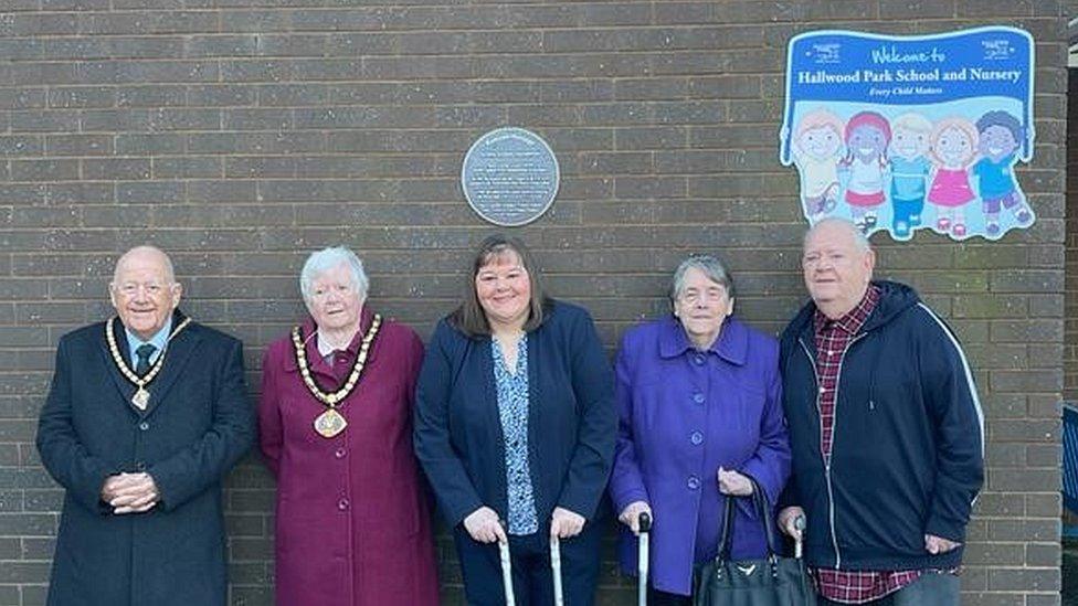 Sue Thompson with her parents and local dignitaries beneath the plaque