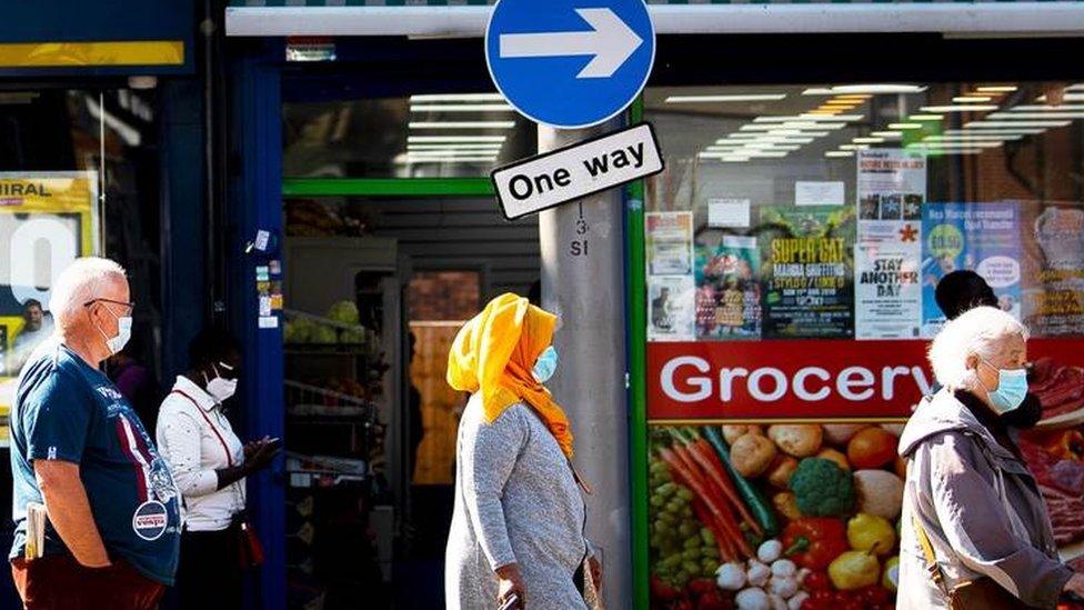 Shoppers queuing in the street