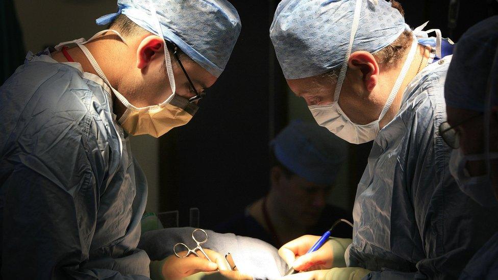 surgeons carry out a transplant