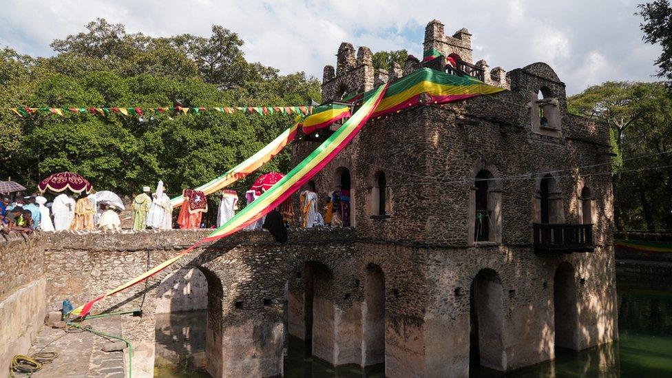 Priests carrying tabots into a castle