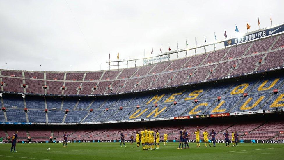 General view as Barcelona's Lionel Messi prepares to take a freekick in the empty stadium