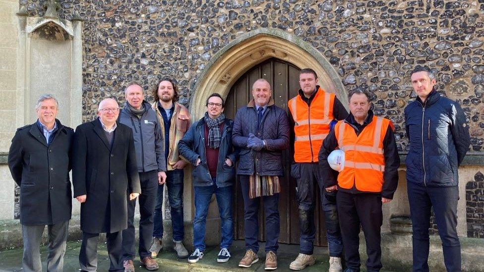 Group photo of councillors, architects, sounds East and members of construction crew outside the church