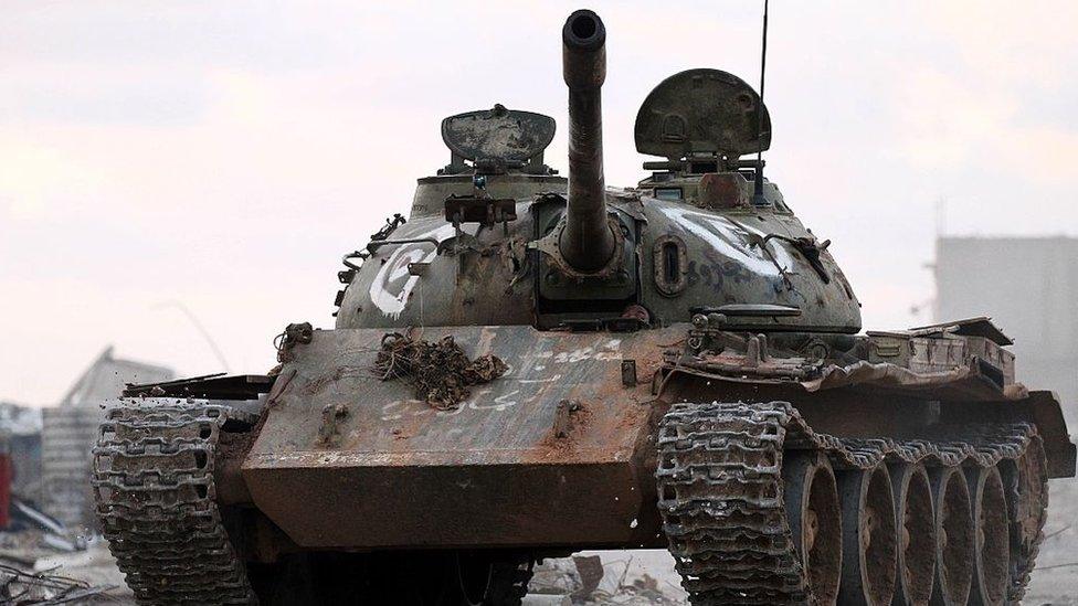 Members of the Libyan National Army (LNA) drive a tank as they hold a position during fighting against jihadists in Qanfudah, on the southern outskirts of Benghazi