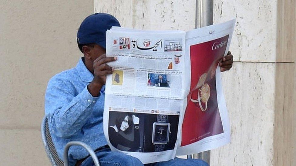 A man reading Al-Hayat newspaper at a cafe in the Saudi capital Riyadh