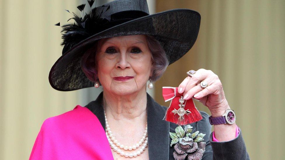 April Ashley with her MBE in 2012