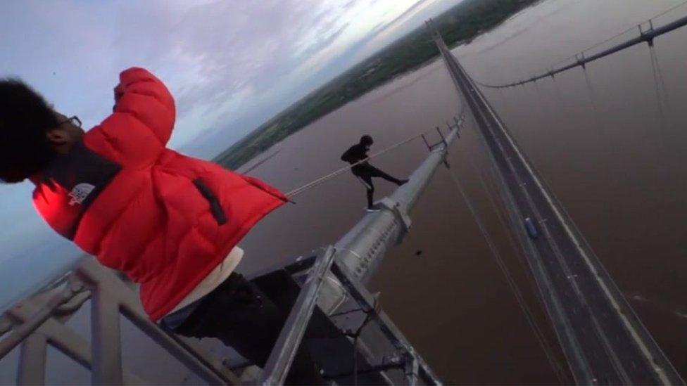 Urban explorers climbing the Humber Bridge