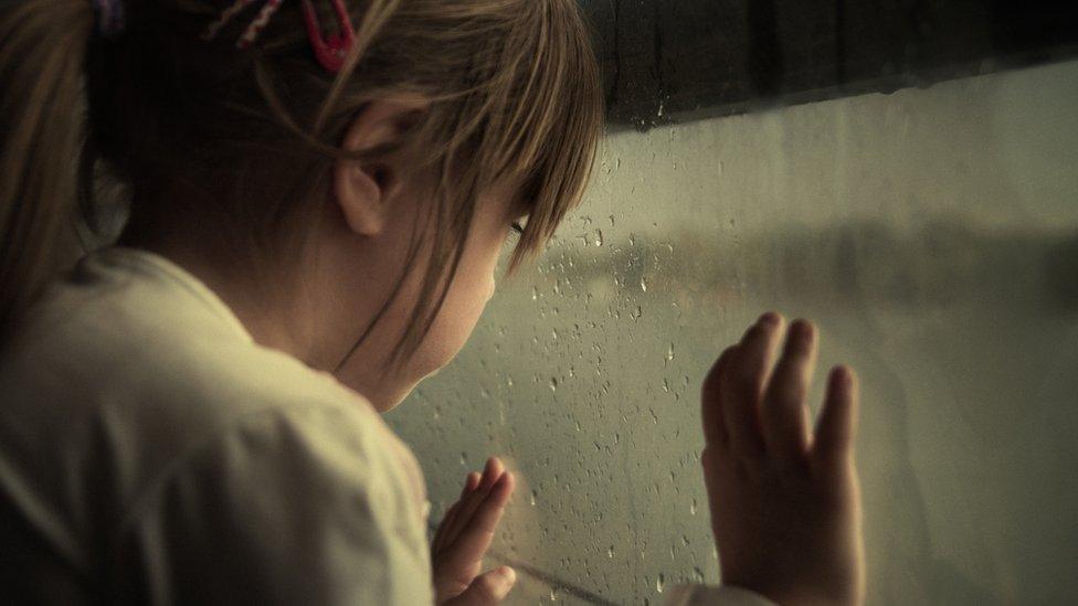 Girl looking out window