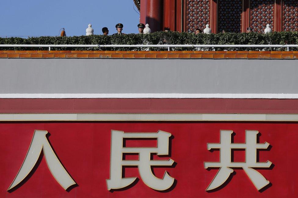 Two paramilitary officers guard Tiananmen Gate in Beijing, China, 29 October 2015.