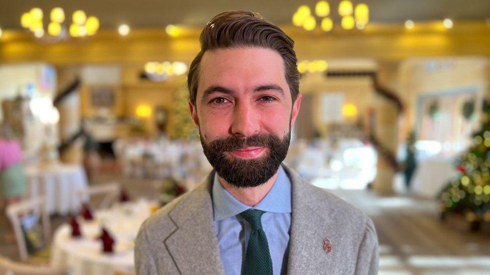 Constantine Innemée, a man with brown hair and a beard in a suit