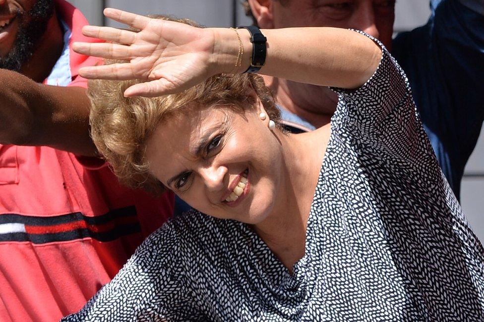 Brazilian President Dilma Rousseff waves from the balcony of Lula's home in Sao Bernardo do Campo, Brazil, 5 March