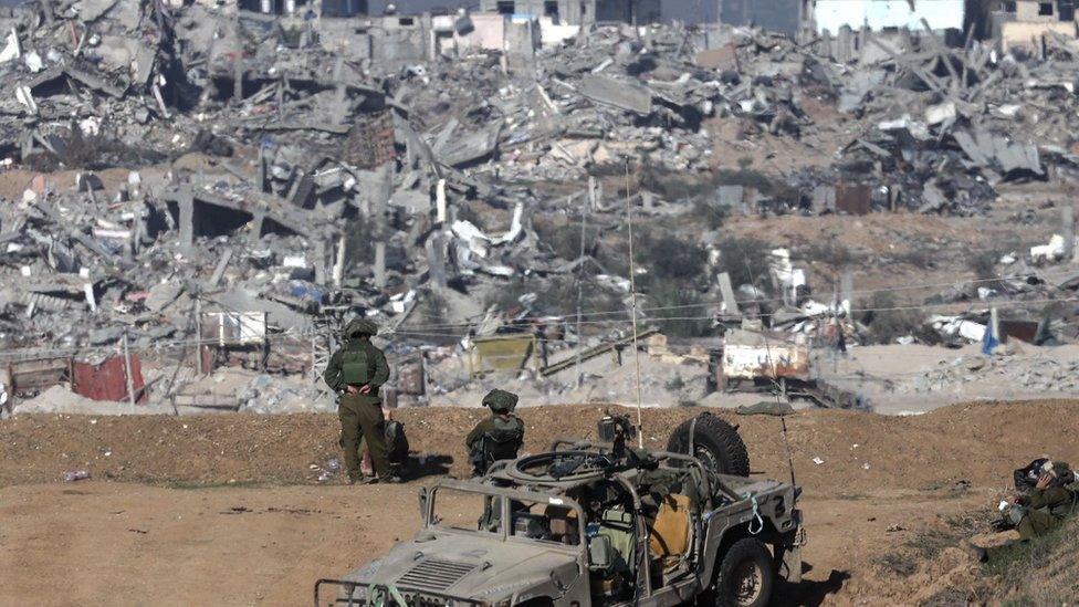 Israeli army soldiers stand guard near the Israel-Gaza border