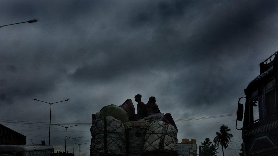 Vegetable vendors travel on a truck with dense clouds are overhead as Cyclone Fani made landfall at neighbouring West Midnapore of West Bengal some 200km west of Kolkata, Eastern India, 03 May 2019